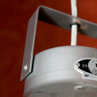 The fixing hook and connection are hidden under a metal cover.