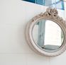 Romantic and retro, this small oval mirror is made entirely of wood