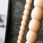 The legs are made up of a series of roundnesses cut from wood.