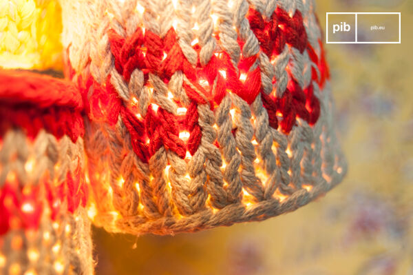 These small hanging lamps that are hung on a white thread are wrapped in knitted fabric and express