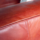 Coral tone of the leather which gives a soft warmth to the sofa.