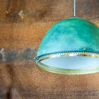 Raw aspect with a matt green patina and very neat golden brass touches.