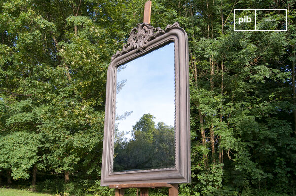 Wooden frame crowned by neat ornaments.