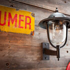 Large exterior wall lamp with raw charm.