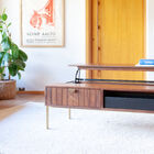 Experience the warmth of dark wood and the refined touch of the matte gold base