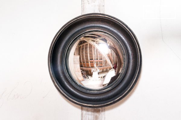 Discreet mirror in a Bohemian country style.