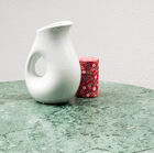 The tabletop itself is made with a beautiful veiny marble that has different tones of green that