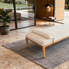 Its low profile and tapered legs are reminiscent of 1950s architectural furniture