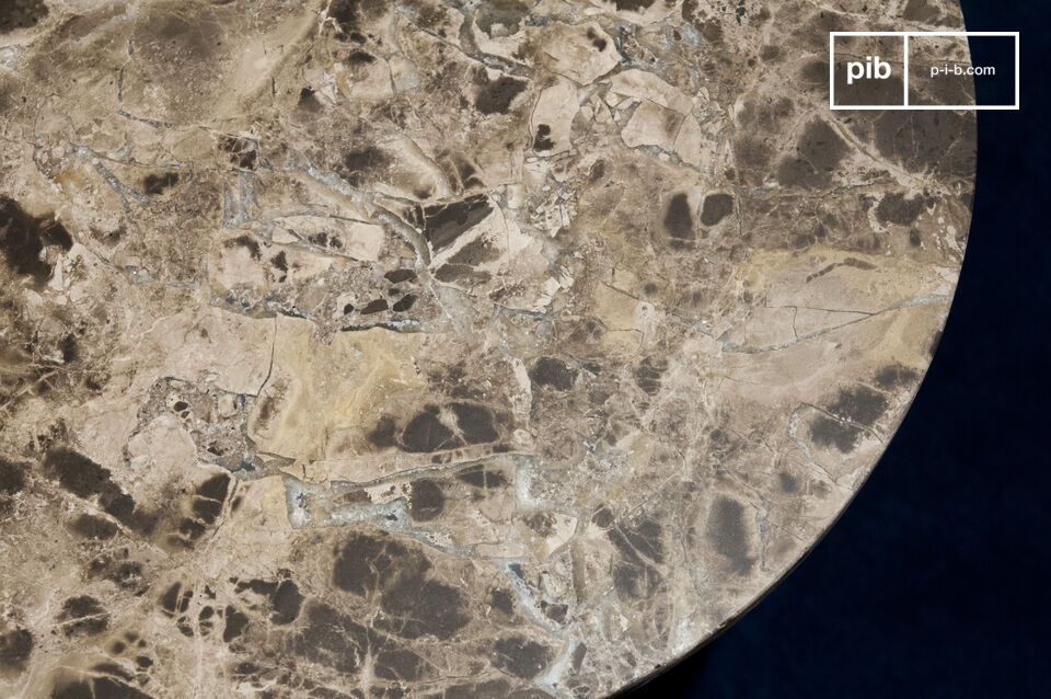 Con su ssuperficie redonda de mármol con nervaduras blancas y tres delgadas patas de metal