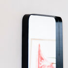 Side photo, the mirror glass is embedded in the black border.