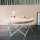 Beautiful round table in light wood with a white metal base.