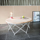 Beautiful round table in light wood with a white metal base.