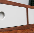 Small round handles embedded in the drawers.