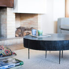 Thick black wooden table with thin metal legs.