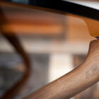 A thick tempered glass top placed on the three arms ensures stability and solidity