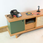 You can change the asymmetry of this sideboard by sliding the rattan doors