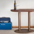 Small teak table with a double central base.