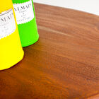 The varnished teak wood top has a pretty brown colour.