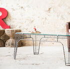 Industrial coffee table with wire mesh.