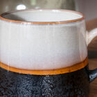 A pair of ceramic cups with a unique look