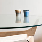 Sturdy tempered glass top resting on a pretty wooden support.