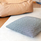 Large white and black decorative cushion with beautiful ethnic motifs.