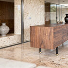 The visual balance is achieved by the combination of the walnut frame and two doors with a sculpted