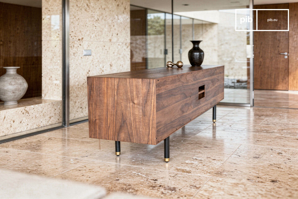 The visual balance is achieved by the combination of the walnut frame and two doors with a sculpted