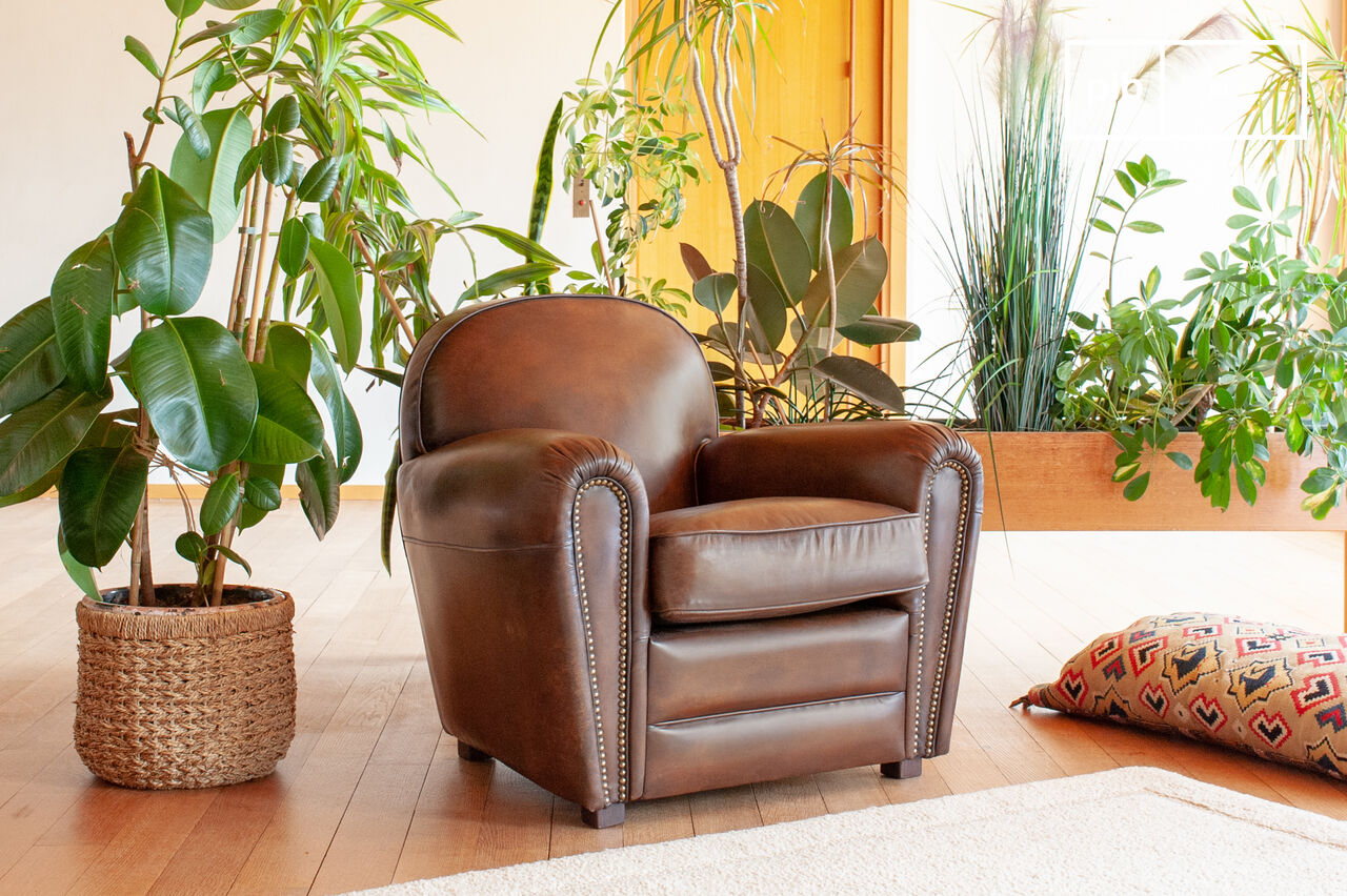 Genuine brown leather vintage-style club chair with visible patina