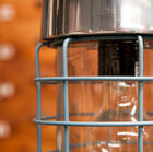 Mesh lampshade with visible bulb.