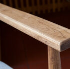 The solid wood armrest retains its organic character.