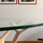 It combines the transparency of a tempered glass tabletop with a sculptural base reminiscent of