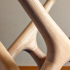 Its tempered glass tabletop rests on a sculpted base