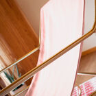 Stretched on a brushed brass tubular structure