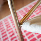 The elegant combination of the light colour of the fabric and the golden brass.