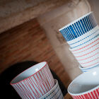 The cups have delicate graphic patterns.