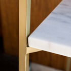 Beautiful gilded metal structure that blends with the pure white of marble.