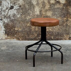 Small stool in brown leather and black metal.