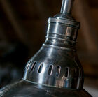 The brass structure is covered with a varnished silver finish.