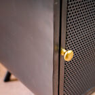 Mesh door and spherical brass handle.