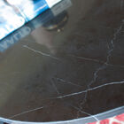 The white veins of the marble top make each piece unique.