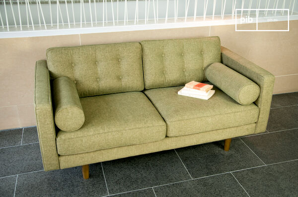 Ein  Design Sofa  im Look der 50er Jahre mit seinen zylinderförmigen Armlehnen und Holzfüßen