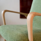 The green velvet upholstery adds a touch of sophistication and freshness while its lines give it a