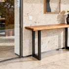 This console table features a solid recycled teak top, selected for its density and character