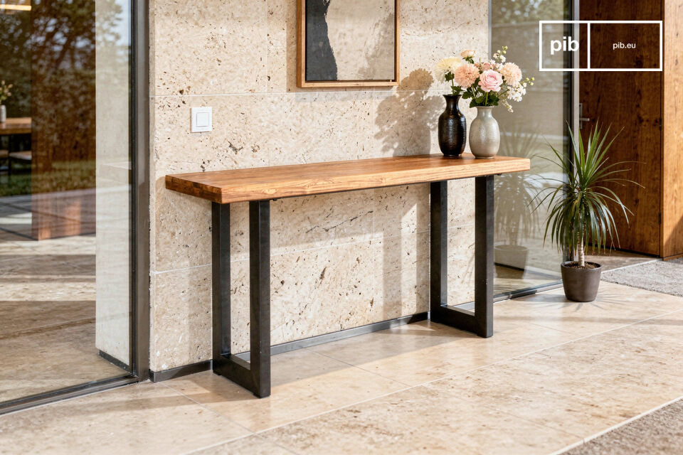 This console table features a solid recycled teak top, selected for its density and character