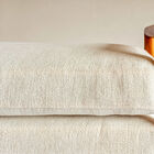 This bench features a solid rubberwood frame with an amber hue and a satin finish that reveals the