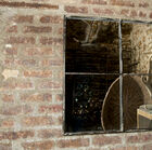 The mirror is divided by two crossed rods into four separate squares of the same size.