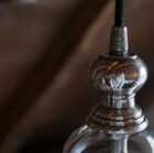 The upper part is made of brass covered with a silver varnish.