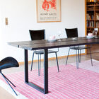 L'épais plateau en frêne teinté sombre donne beaucoup de présence à la table.