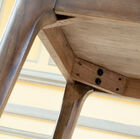 The table is stable on its varnished oak base.